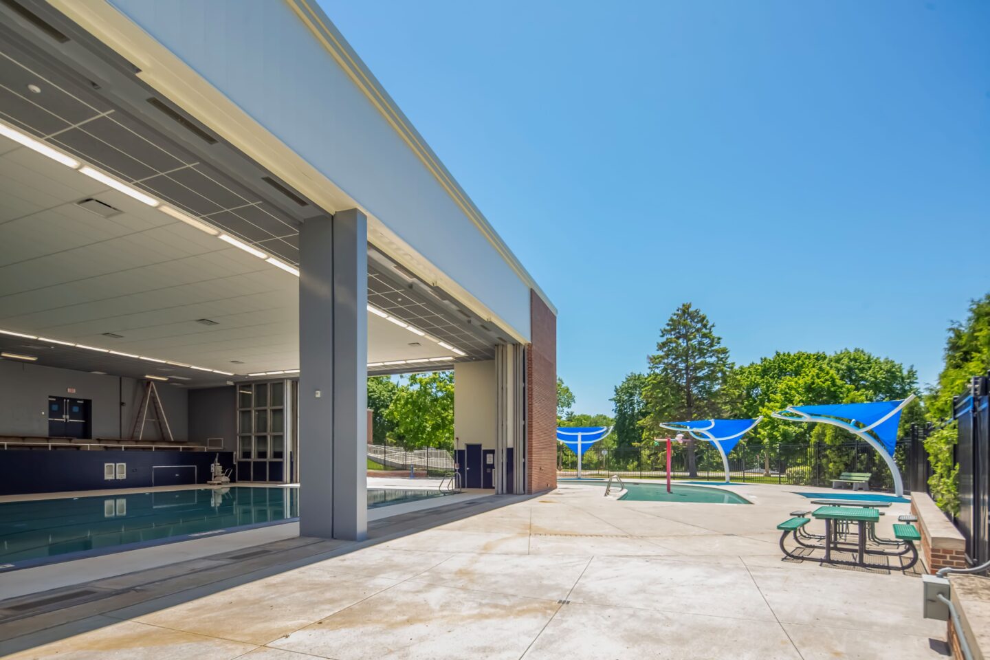 Outdoor pool looking at indoor pool with the doors open