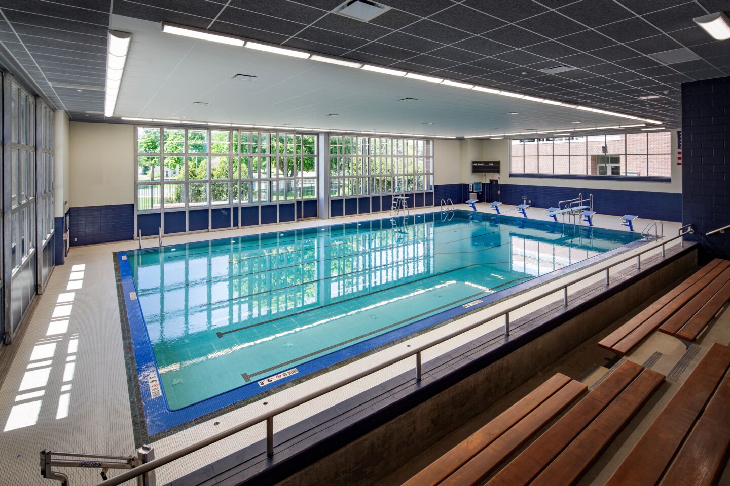 Indoor pool standing on bleachers; doors closed to outdoor pool